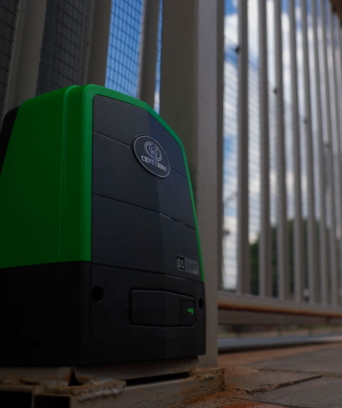 Centurion D5 SMART electric gate motor installed beside a metal security gate outdoors