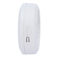 White round smoke detector with micro SD card slot and reset button, side view