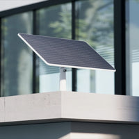 EZVIZ 24W solar panel mounted outdoors on a wall
