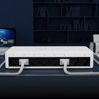 Network switch with ethernet cables on office desk, computer and printer in background