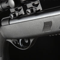 Close-up of a black air rifle trigger and scope mount with textured grip