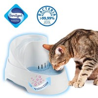 Tabby cat drinking from a white antibacterial pet water fountain with sanitized protection symbols.