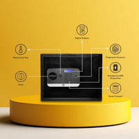 Black electronic safe with digital display, fingerprint scanner, keypad, USB port, and mechanical key on a yellow platform.