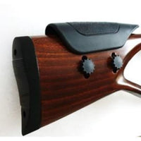 Close-up of wooden air rifle stock with adjustable cheek rest and textured butt pad